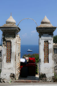Exterior of building by sea against blue sky