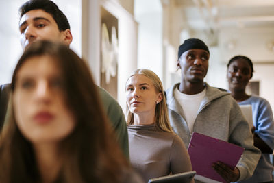 Side view of young woman using mobile phone