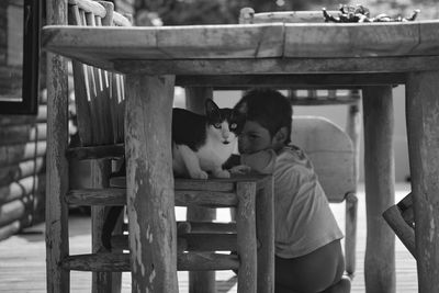 Cat and child under the table