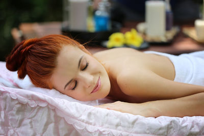 Portrait of woman lying on bed