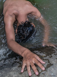 High angle view of shirtless man in water