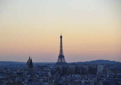 Buildings in city against sky during sunset