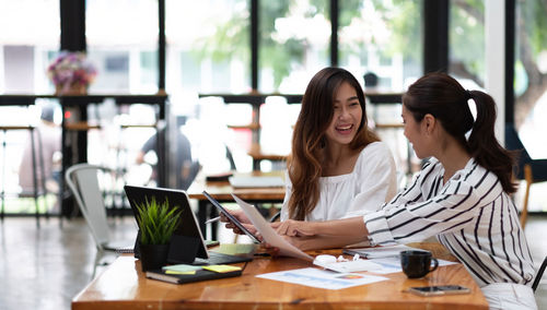 Woman using smart phone on table