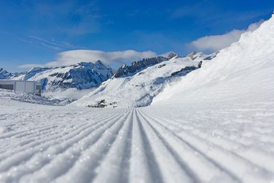 Scenic view of snow covered mountains against sky