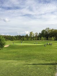 People playing golf on field