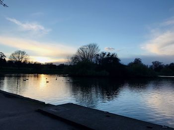 Scenic view of lake against sky during sunset