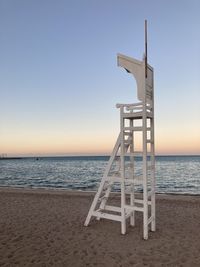 Lifeguard hut on beach against clear sky