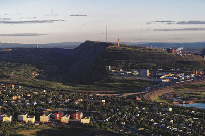 High angle view of iron ore mine against sky in town