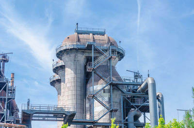 Low angle view of factory against sky