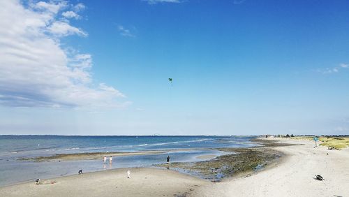 Scenic view of beach against blue sky