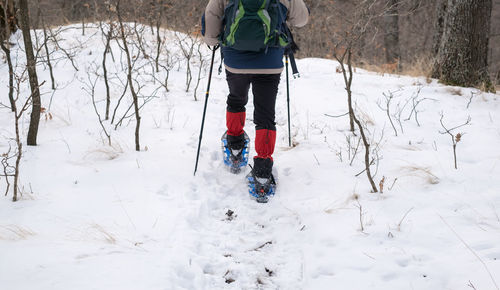 Low section of man on snow covered field