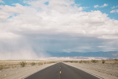Empty road against cloudy sky at death valley national park