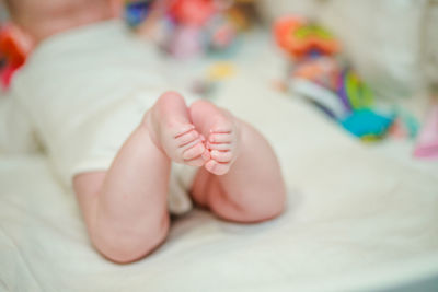 Close-up of baby on bed at home