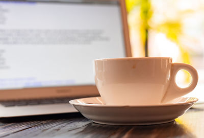 Close-up of coffee cup on table