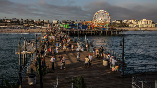 High angle view of people on pier by sea against sky