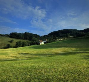 Scenic view of golf course against sky