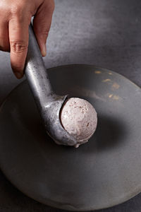 Cropped hand of person holding mortar and pestle