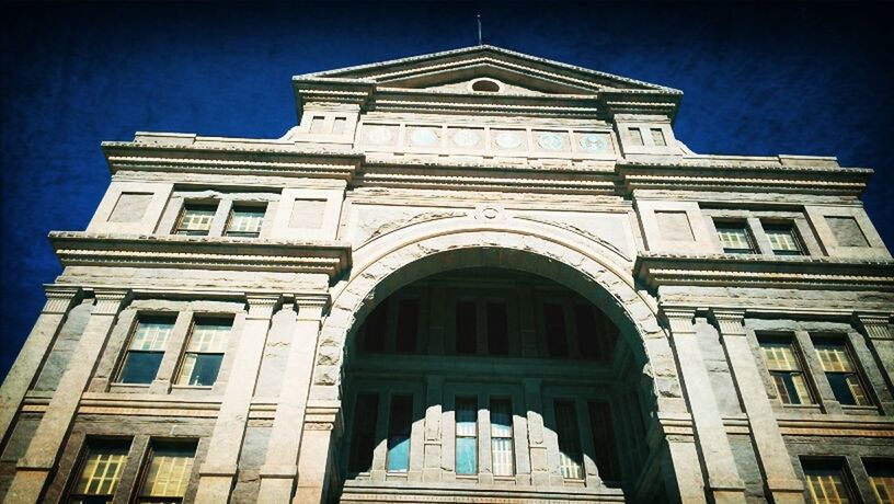 architecture, built structure, building exterior, low angle view, window, arch, facade, church, city, building, blue, day, sky, architectural feature, history, outdoors, religion, no people, clear sky, travel destinations