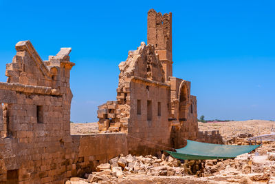 Old ruin building against blue sky