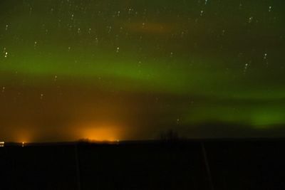 Silhouette of trees against sky at night