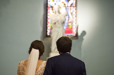 Rear view of couple standing in church