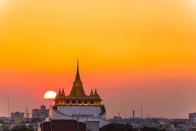 View of buildings against sky at sunset