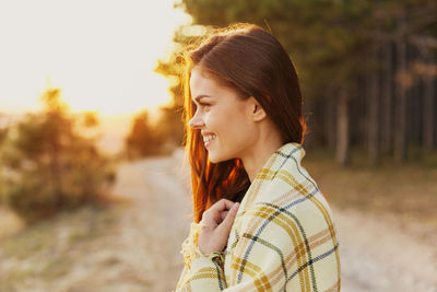 Portrait of young woman standing outdoors