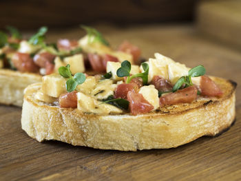 Close-up of open sandwich served in wooden plate