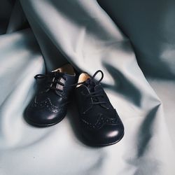 High angle view of black shoes on bed