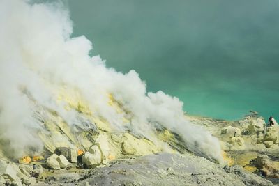 Scenic view of smoke emitting from hot springs at ijen