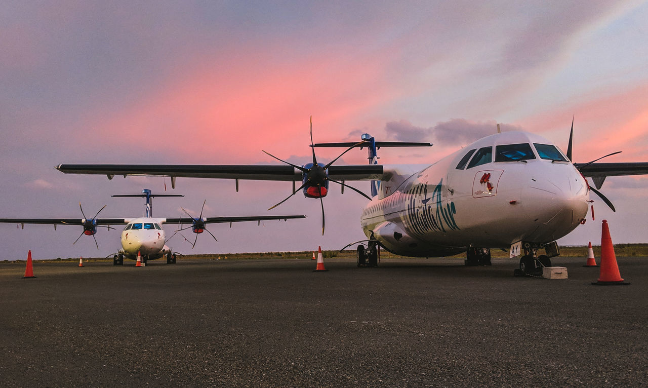 air vehicle, airplane, transportation, mode of transportation, sky, airport, airport runway, sunset, travel, nature, cloud - sky, commercial airplane, public transportation, stationary, outdoors, runway, no people, sunlight, aerospace industry, aircraft wing, private airplane, plane