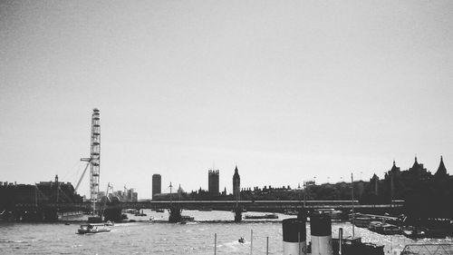 River and buildings against clear sky