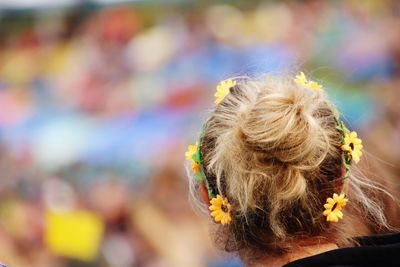 Rear view of woman with blond hair wearing flowers
