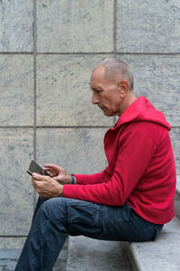 Side view of man using mobile phone