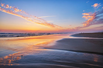 Scenic view of beach against sky during sunset