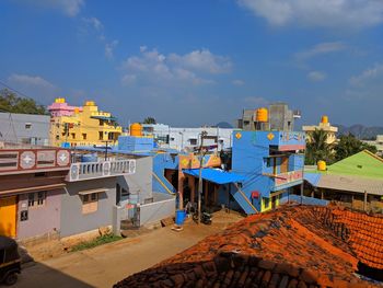 Houses and buildings in town against sky