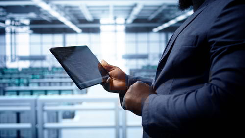 Midsection of businessman using mobile phone