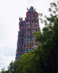 Low angle view of sculptures on building against sky