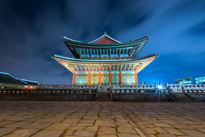 Illuminated building against sky at night