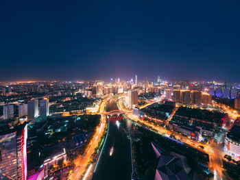 High angle view of illuminated buildings in city at night