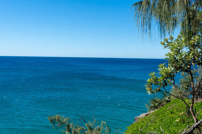 Scenic view of sea against clear blue sky