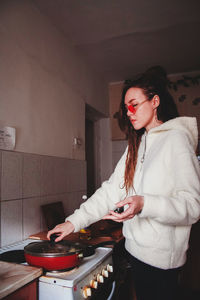 Young woman cook a food at home