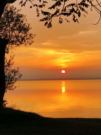 Scenic view of sea against romantic sky at sunset