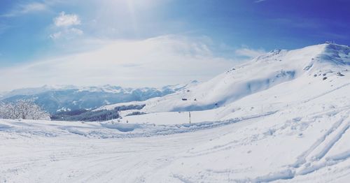 Scenic view of snow covered mountains against sky