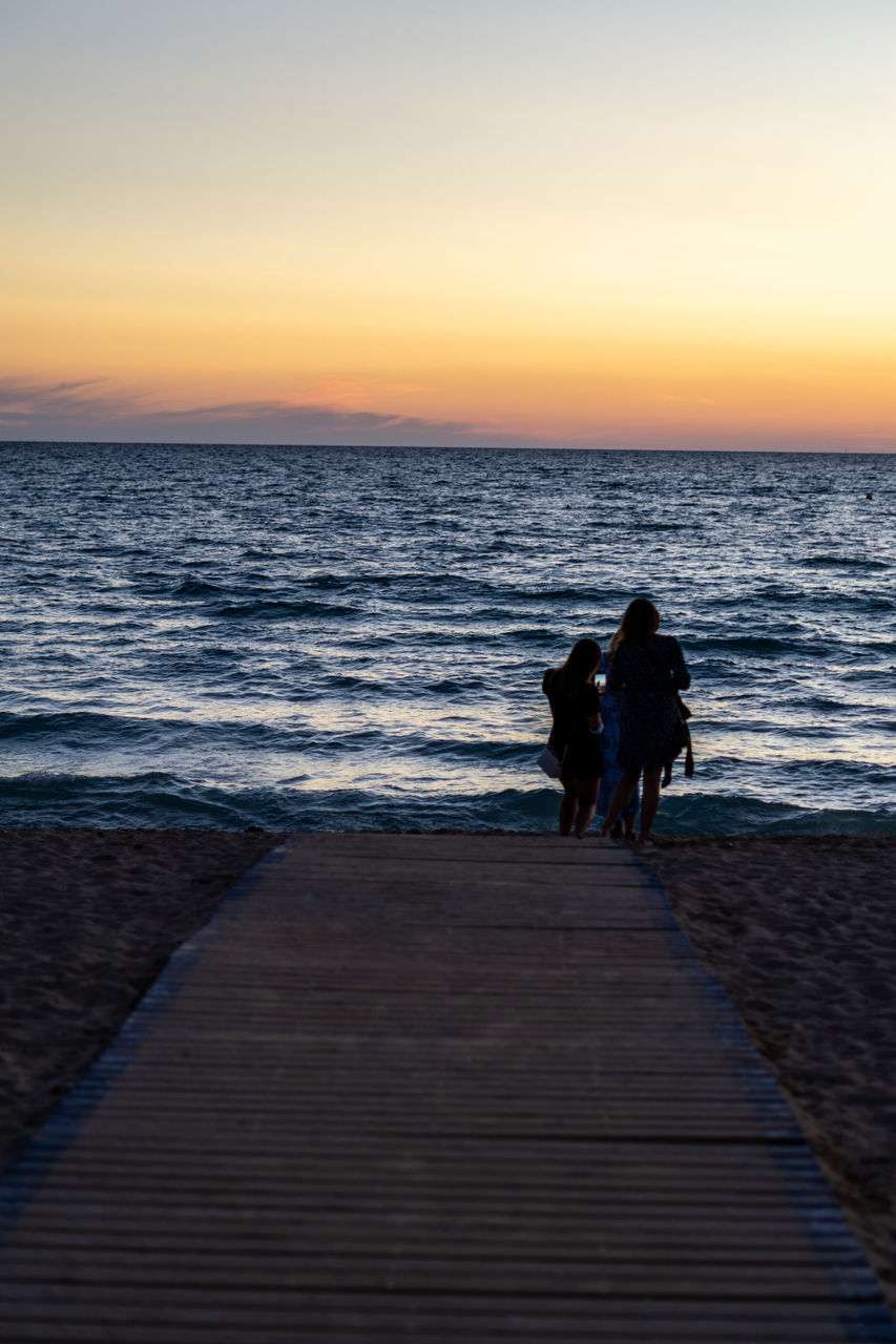 PEOPLE ON BEACH DURING SUNSET