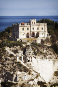 Castle by sea against sky