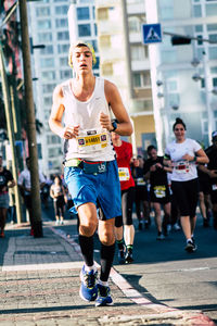 Full length of man running in city
