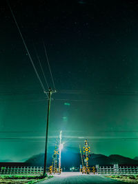 Illuminated railroad crossing at night