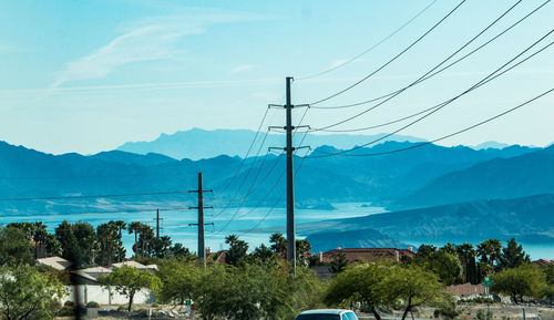 Scenic view of mountains against blue sky