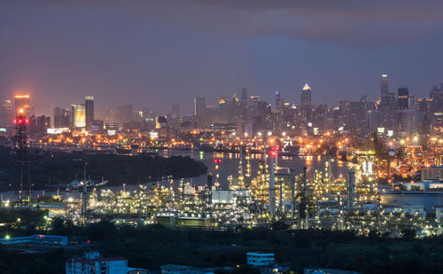 High angle view of illuminated buildings against sky at night